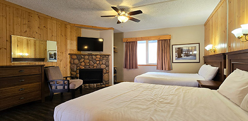 A interior image of the newly renovated Aspen Double Queen with Kitchenette suite.